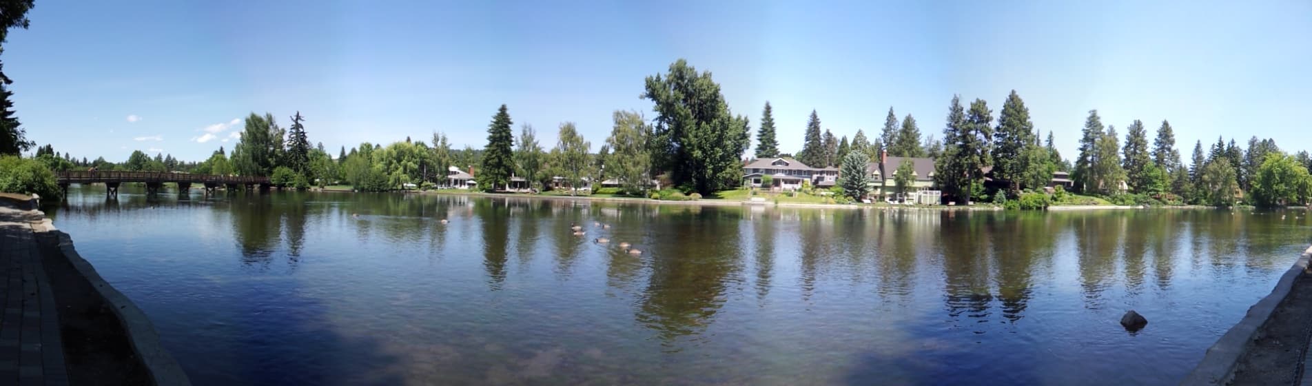 A Central Oregon landscape along the Deschutes River near Bend, showing pine trees and high desert terrain typical of the wildland-urban interface.